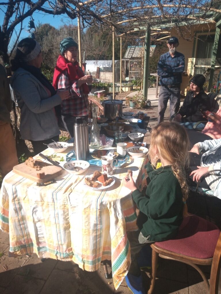 Volunteers on Tanglewood Farm sharing a meal after learning permaculture methods. And healing society while healing the land.